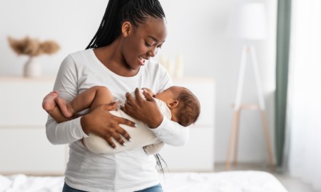 infant mortality, systemic racism, racial disparity grants: happy black mother and baby in white room